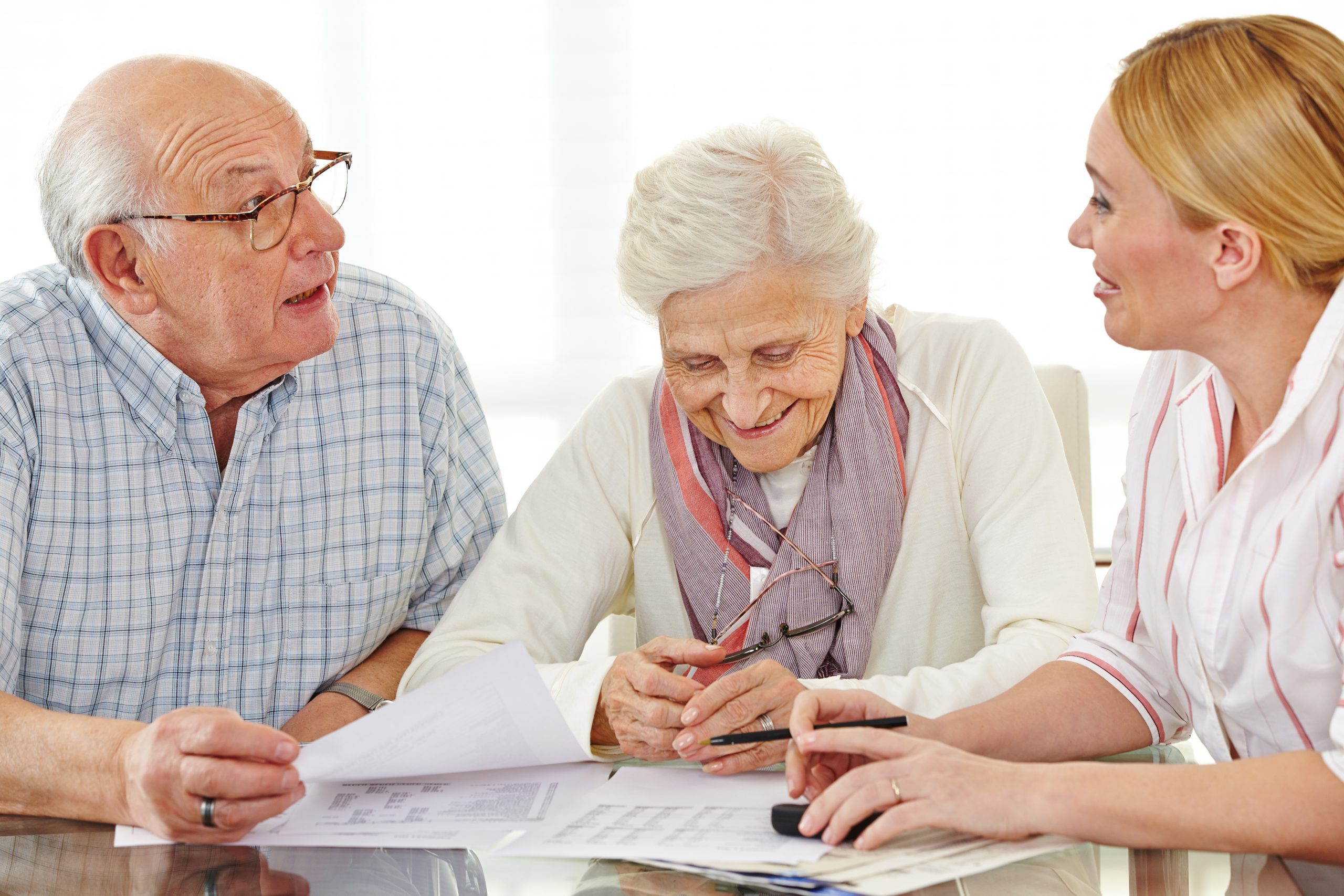 Older adults reviewing Special Needs Plans (SNPs) information with an advisor.